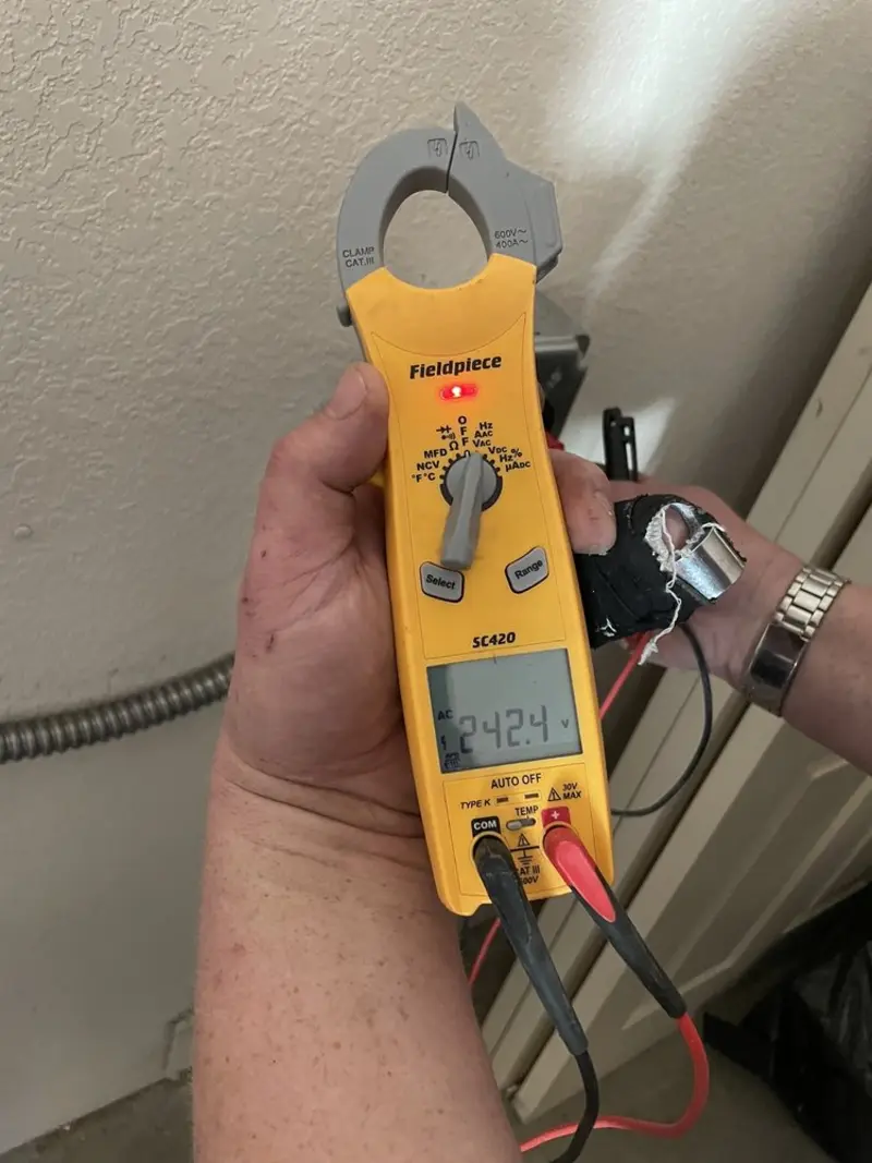Voltage testing with clamp meter during Recessed Lighting Installation in LaBelle